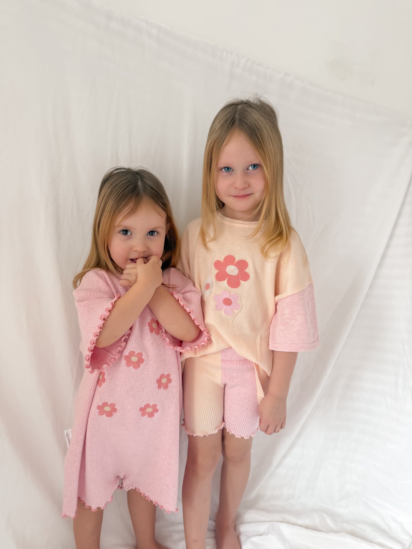 Girls siblings matching outfits. Pink over sized play suit and oversized top and cycle shorts set