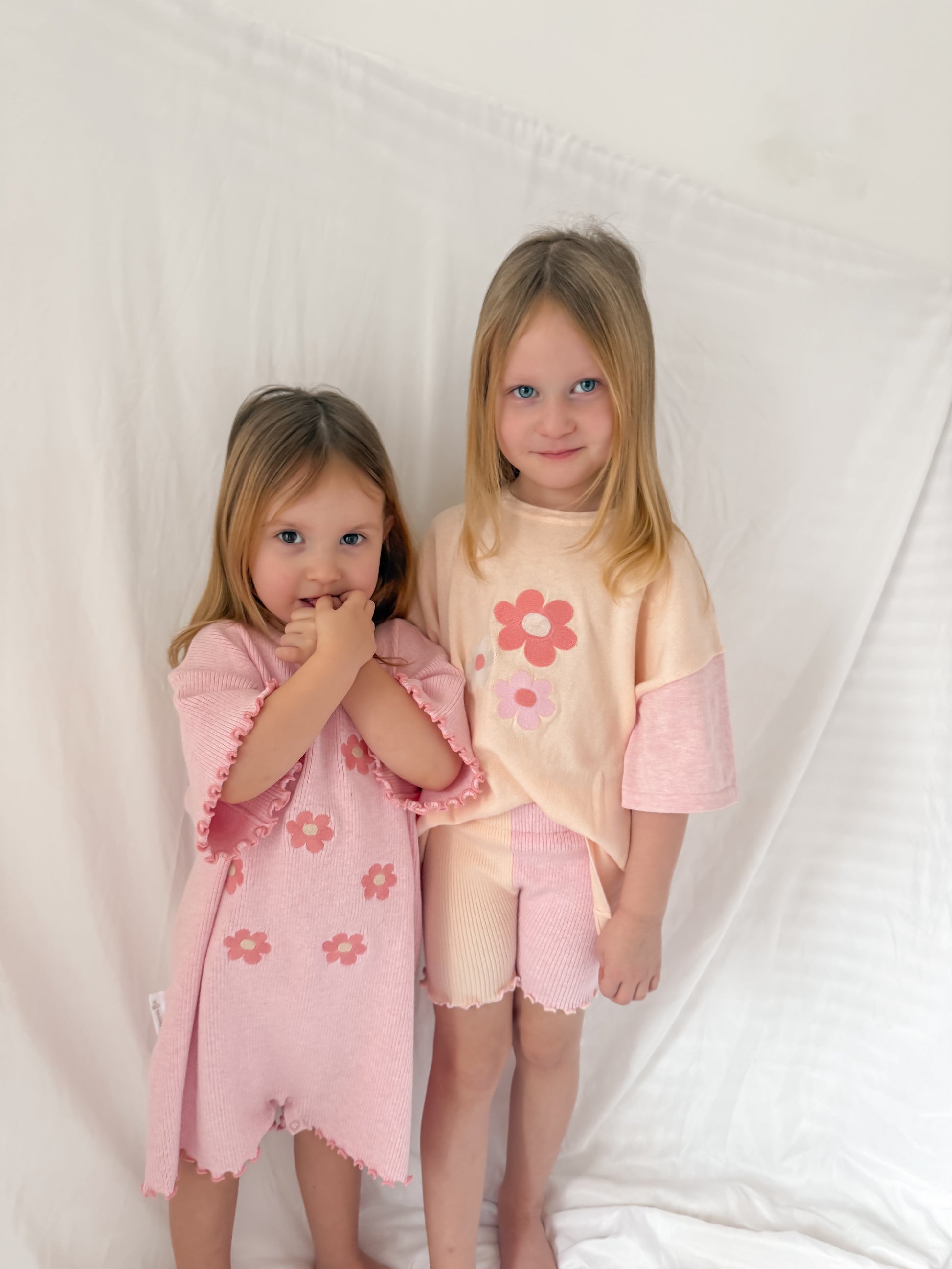 Girls siblings matching outfits. Pink over sized play suit and oversized top and cycle shorts set