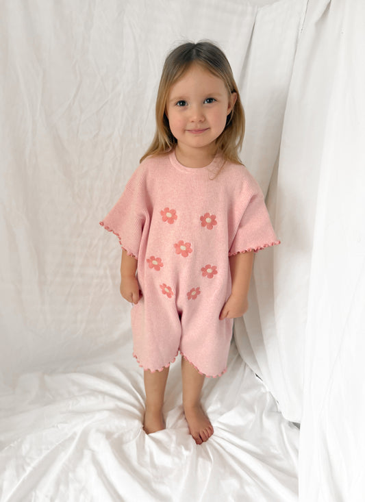 Girls oversized pink knit 100% cotton ribbed playsuit with embroidered flowers and frill edge detail